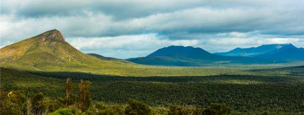 Stirling ranges national park panoramic in Western Australia Stirling ranges national park panoramic.  A wide sweeping view across the valley floor to a tor and mountain range beyond in distance. bluff knoll stock pictures, royalty-free photos & images