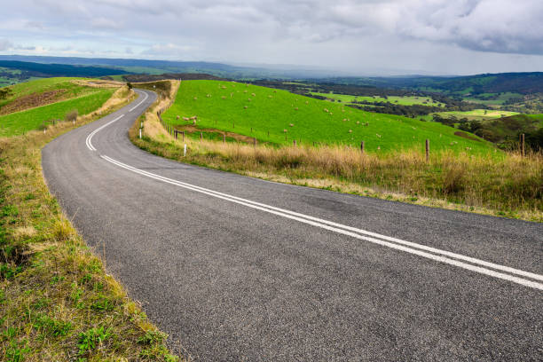 Winding road through Adelaide Hills farms Winding road through Adelaide Hills farms during winter season, South Australia country road stock pictures, royalty-free photos & images