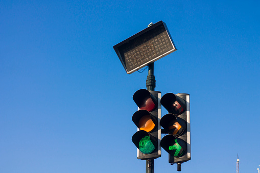 Low Angle View Of traffic lights Against Blue Sky. urban traffic lights