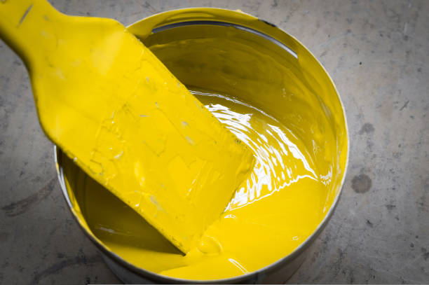 istock A can of yellow polygraph offset paint for the printing press. Special UV ink for printing. Open new can of yellow paint. Selective focus 1432755752