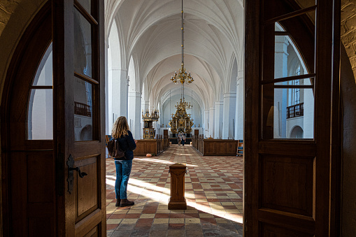 Maribo, Denmark  A woman stands in the entrance to the  Maribo Cathedral.