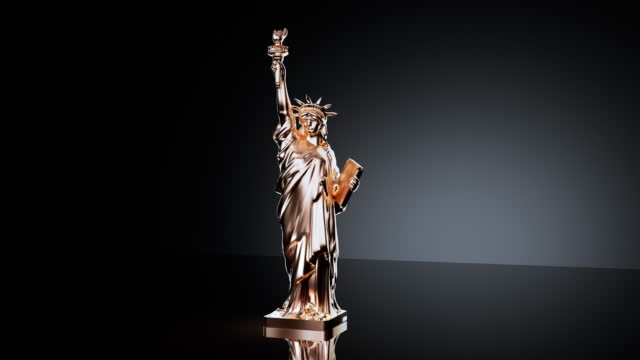 Small gray souvenir Statue of Liberty covering in gold color
