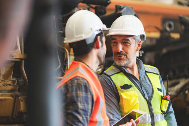 istock professional industrial engineers in hard hats. working at heavy industry manufacturing factory, man worker in an construction industrial job, maintenance service check for safety first concept 1432762507