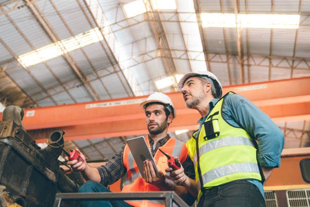istock professional industrial engineers in hard hats. working at heavy industry manufacturing factory, man worker in an construction industrial job, maintenance service check for safety first concept 1432762576