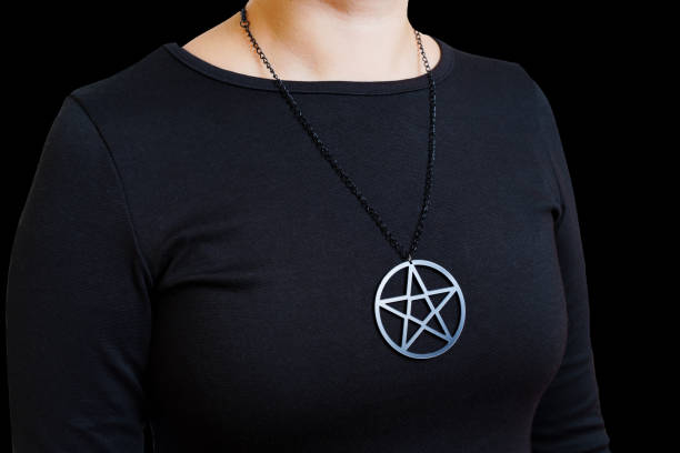 istock Woman in black wearing a pentagram pendant 1432764673