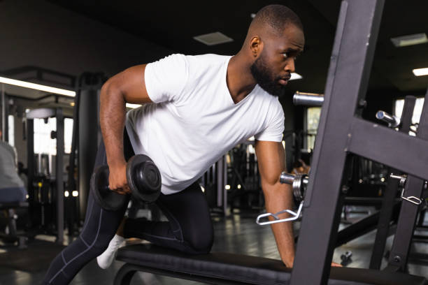 istock Fit and muscular african man trains with dumbbells. 1432767096