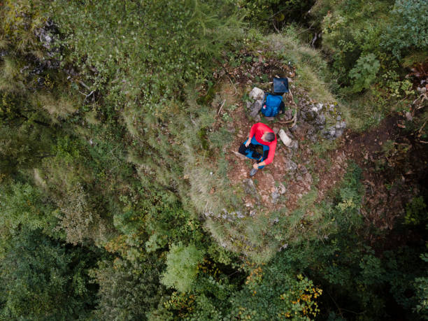 istock Hiker, middle-aged climber is on rock, surrounded by forest and makes recording of himself with a drone, lilienfeld, austria 1432768377
