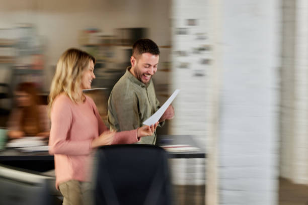 istock Happy creative colleagues reading reports on the move in the office. 1432771962