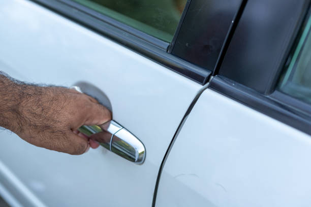 istock Man holding a car door handle to open a car door 1432772178