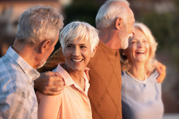 istock Happy senior friends walking embraced in nature. 1432772377