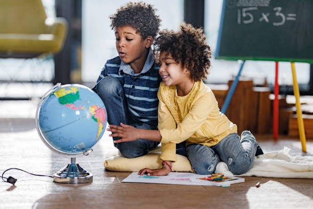 istock African American kids exploring globe at home. 1432773183