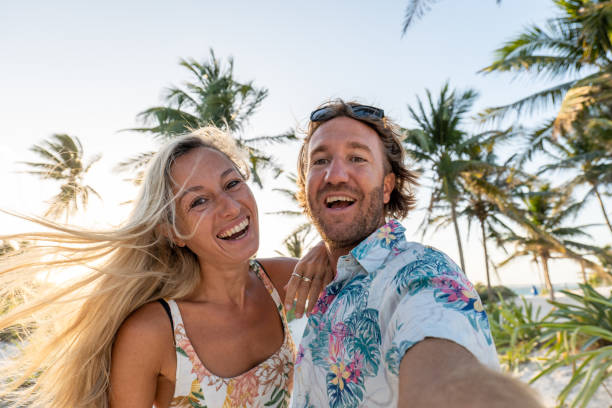 istock Couple takes selfie on tropical beach at sunset 1432773969