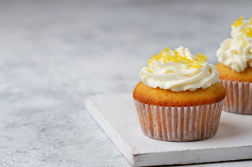 Cupcake with lemon on a concrete table close up, copy space