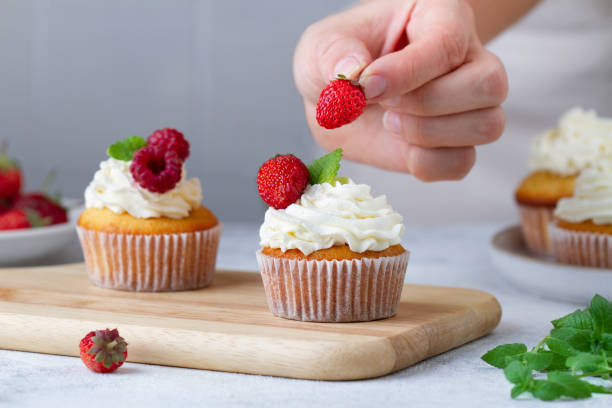 istock Hand decorating cupcakes with berries,  Part 8/9 1432776683