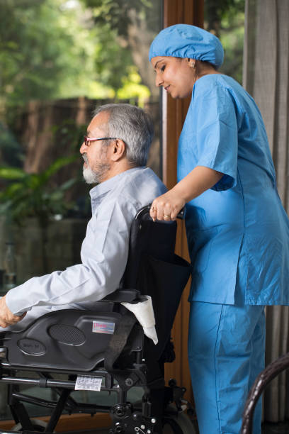 istock Nurse with disabled man on wheelchair at home 1432776765