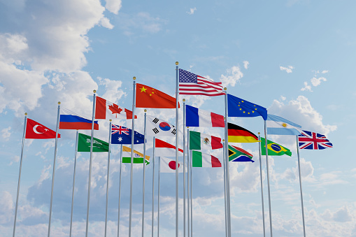 G20 flag summit Silk waving flags countries of members Group of Twenty political 2022 world leaders unity meeting G 20 organization with flagpole on background blue sky with clouds