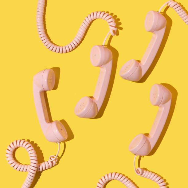 istock Creative layout with pink retro phone handsets on bright yellow background. 80s or 90s retro fashion aesthetic telephone concept. Minimal romantic handset idea. Valentines day idea. 1432778270