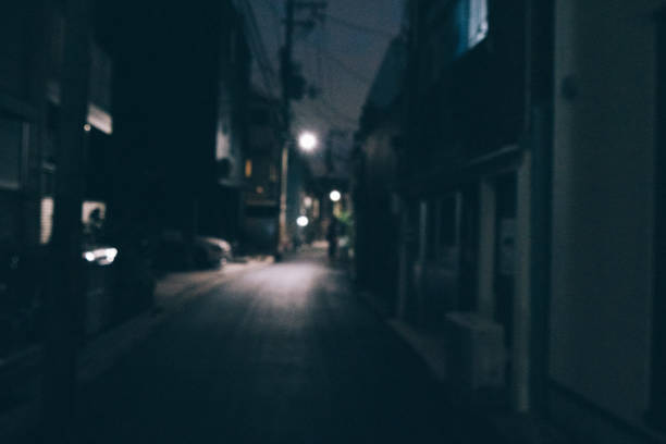 Defocused blurred image of dark street