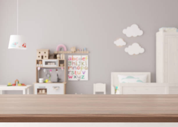 istock Empty wooden table top and blured kids room interior on the background. Copy space for your object, product presentation. 3D rendering. 1432778450