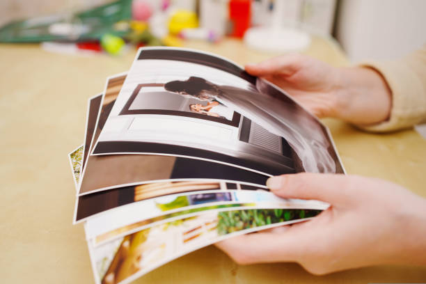 istock printed wedding photos in the women hands. 1432779159