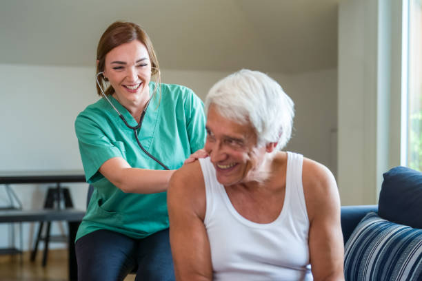 istock Young caregiver helping senior man at home and checking vital parameters, nurse assisting her old man patient at nursing home, friendly nursing home lady doctor with senior 1432780357
