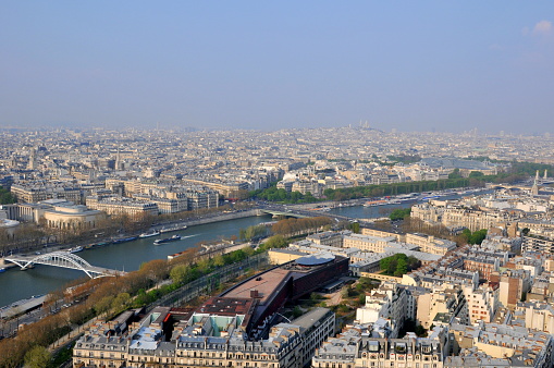 Paris, France- April 10, 2010: Paris is the center of French economy, politics and cultures and the top travel destinations in the globe.  It attracts the tourists all over the world.  Here is the aerial city view of Paris seen from Eiffel Tower.