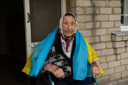 elderly woman with the flag of ukraine.