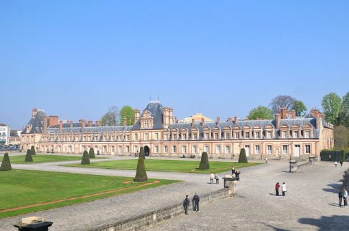 Paris, France- April 10, 2010: Paris is the center of French economy, politics and cultures and the top travel destinations in the globe.  It attracts the tourists all over the world.  Here is Chateau de Fontainebleau.