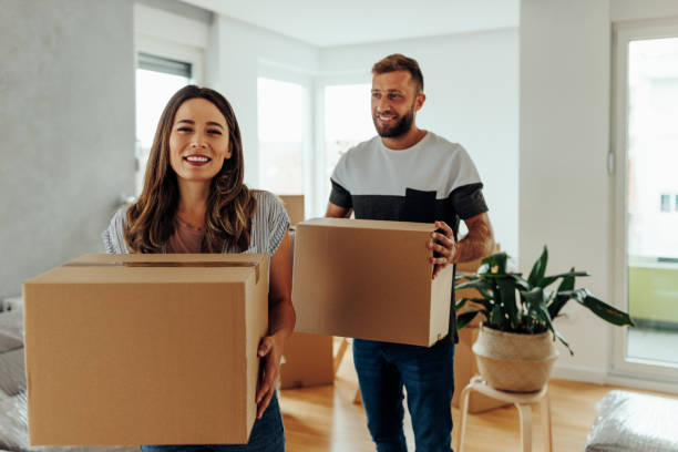 istock Happy couple moving and carrying boxes 1432784517