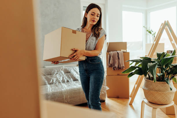 istock Woman moving into new house. 1432784576