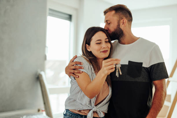 istock Enthusiastic couple with home keys. 1432784934