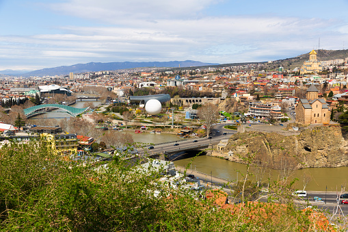 Beautiful view of Kura river and Bridge of Peace in Tbilisi, Georgia