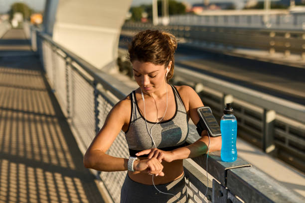 istock Female runner checking info on smart watch 1432786787