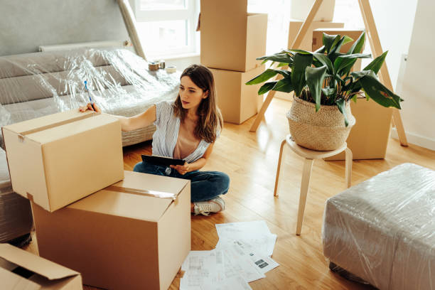 istock Woman unpacking in new apartment. 1432787912