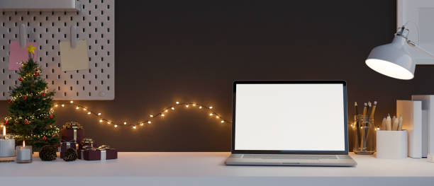 istock Comfortable home working desk with Christmas decoration, laptop mockup, Christmas light 1432792226