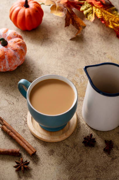 istock Coffee with milk or latte with cinnamon in blue ceramic cup. Autumn comfort drink. 1432795101