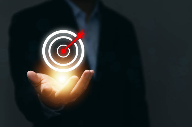 istock Businessman showing virtual digital technology darts icon Red arrows on the board. objective concept and goals for business investment Marketing Strategy and Aims for Success 1432797906