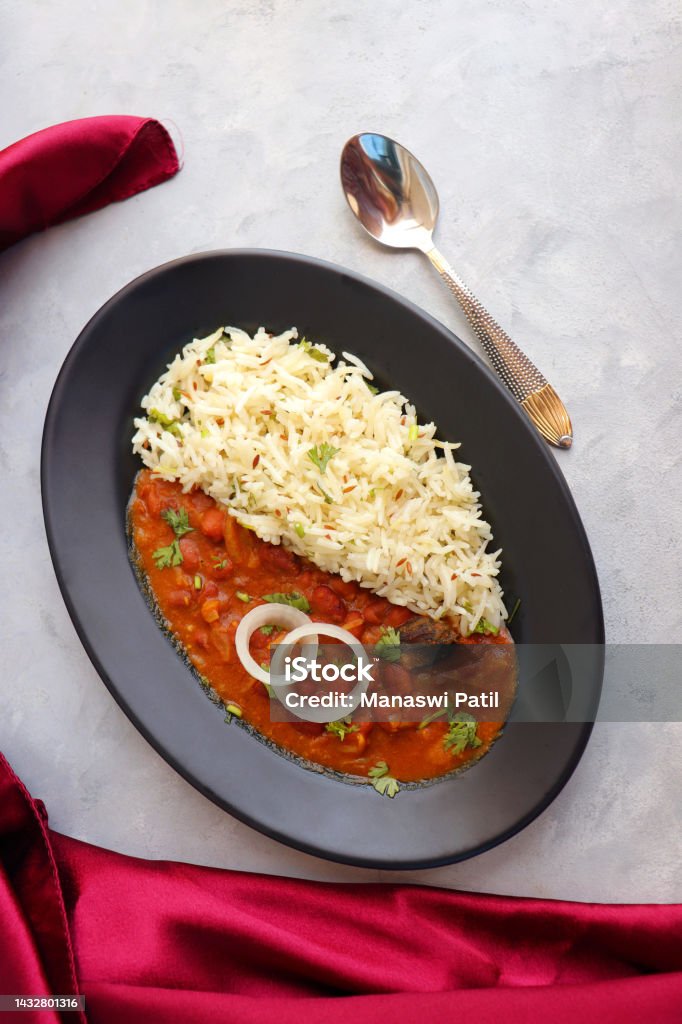 Rajma Chawal is a popular North Indian Food. Rajma is a socked Red kidney beans cooked with onions, tomatoes and a special blend of spices. Served with Jeera rice or Cumin Rice. With Copy Space. Rice - Food Staple Stock Photo