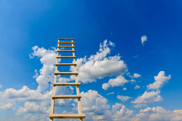 Development, Attainment ,Motivation. Career Growth Concept.Wooden Ladder Leading To A Blue Cloudy Sky.Copy space.