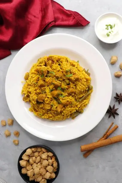 Soya chunks Biryani. Basmati rice cooked with Soyabean or Soya vadi along with spices and vegetables. It's a complete protein rich and nutritious one pot meal. Copy space