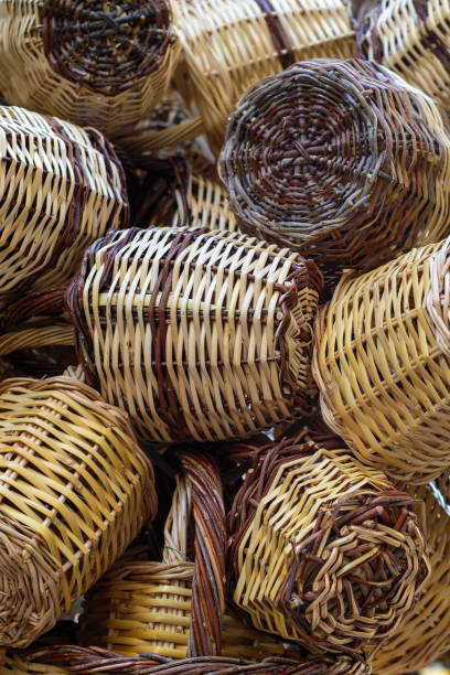 istock Closeup on group of handmade wicker rustic baskets container for shopping. Natural colors and texture. Eco concept. Wooden hanging wicker pots. Traditional greek street shop. Vertical. Soft focus 1432805851