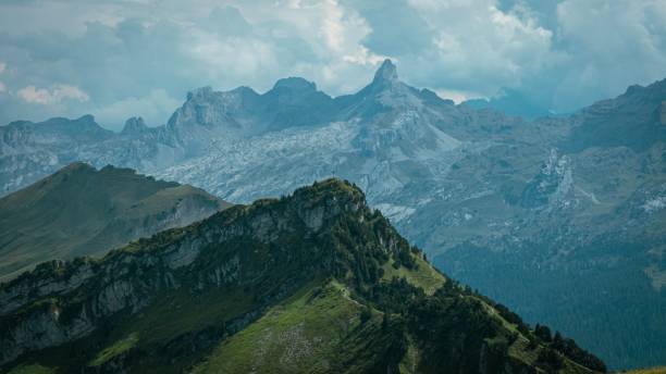 istock High angle view of mountain peaks surrounded by greenery 1432808296