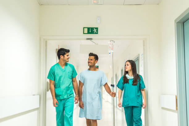 istock Medics and patient in hall 1432808809