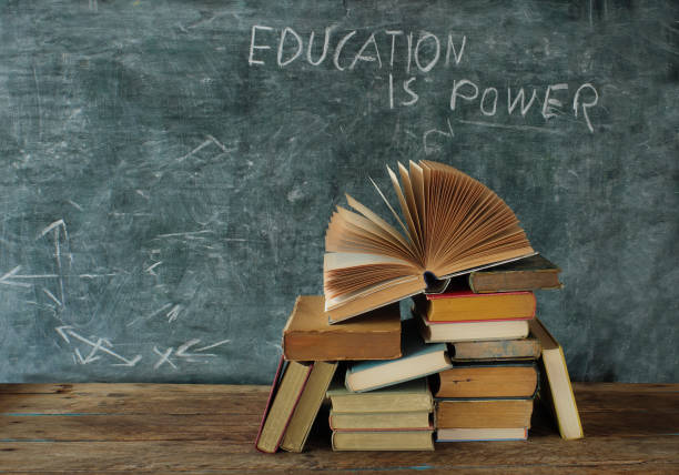 istock Open book, hardback books with education is power slogan on blackboard,education,learning and reading concept. Free  copy space 1432809643