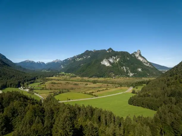 A scenic shot of grass fields and the Kofel mountain in the Bavarian Alps in Germany