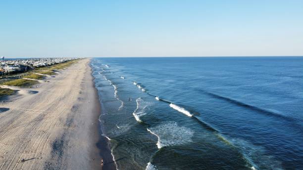 istock Scenic view of sandy beach and blue sea waves 1432810994