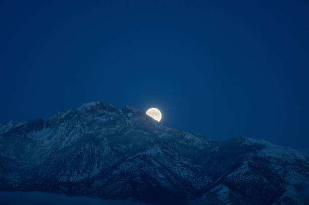 istock Scenic shot of a full moon behind the mountains 1432811006