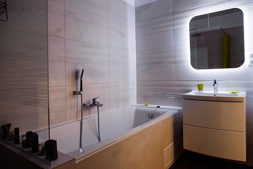 An interior of a modern bathroom with a bath tub