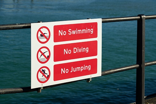 The no swimming, no diving, and no jumping sign.