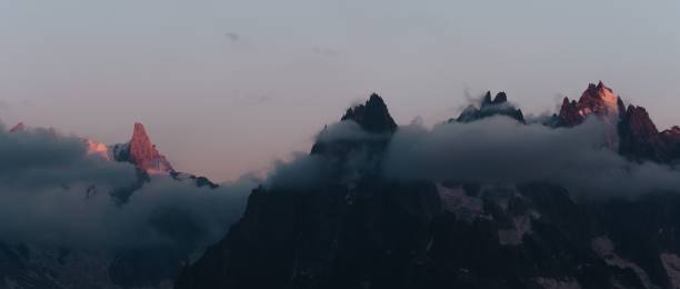istock Panoramic shot of rocky mountains covered with clouds 1432811858